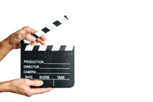 man hands holding a movie clapperboard