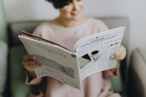 Happy woman reading a magazine